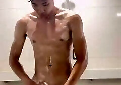 Uncut Chinese boy bathing in a public swimming pool
