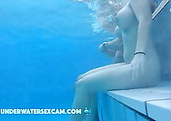 This lovely girl shows her big tits underwater in the pool while the cam is watching her!