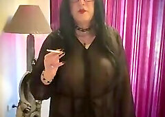 Crossdresser smoking in transparent dress
