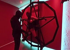 Strapped to a Satanic cross and orgasms with a magic wand, while she gets electric shock that makes sparks fly.