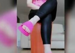 Raven is wearing latex panties, a fuchsia reservoir top, and fuchsia slips. That babe sits down and taps her foot with her legs crossed. Toes with chr